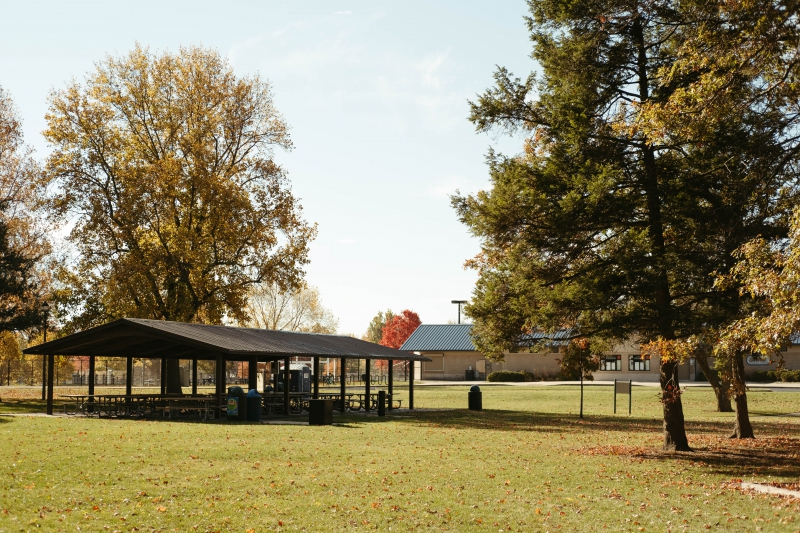 a large pavilion with seating and grills 