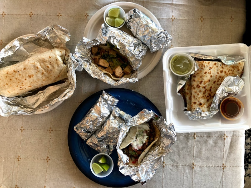An overhead shot of Taco Shack's meals on a brown tablecloth. Photo by Remington Rock.