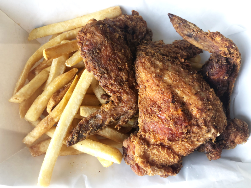 An overhead shot of a wings meal from The Stuft Bird with a side of fries and three giant wings. Photo by Alyssa Buckley.