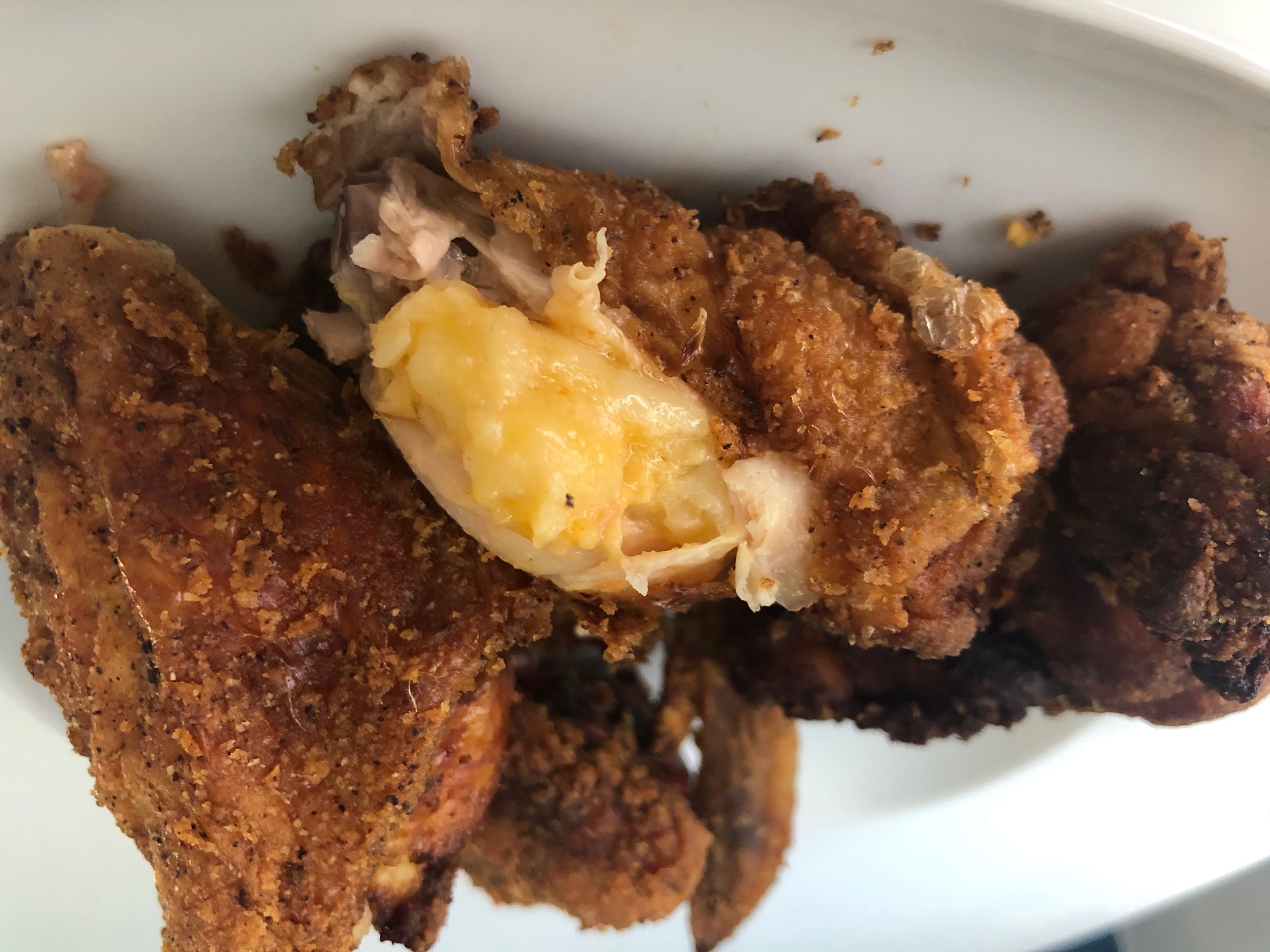 The Stuft Bird's macaroni wing is sliced to reveal the cheesy macaroni inside the fried chicken skin. Photo by Alyssa Buckley.