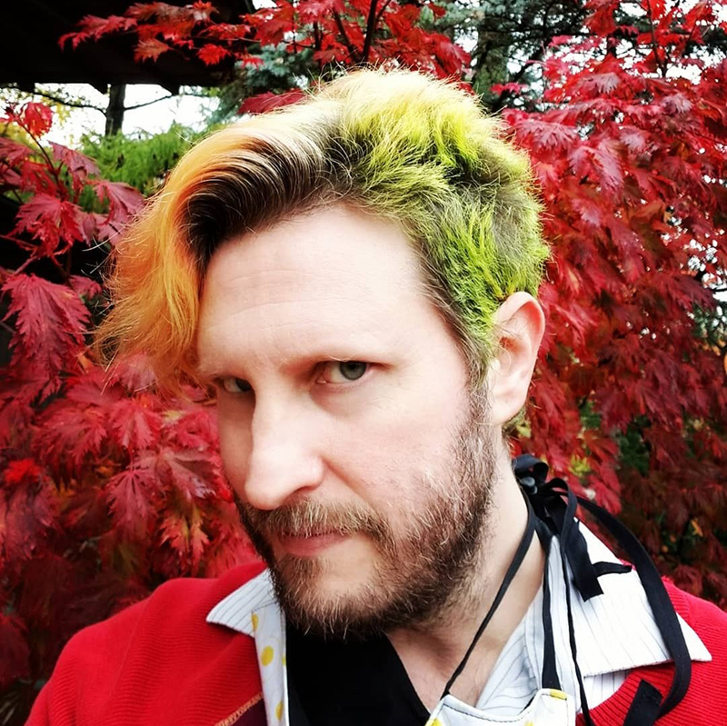 Close up photo of Marc-Anthony Macon in front of Japanese Maple Tree. Photo from Macon's Facebook page