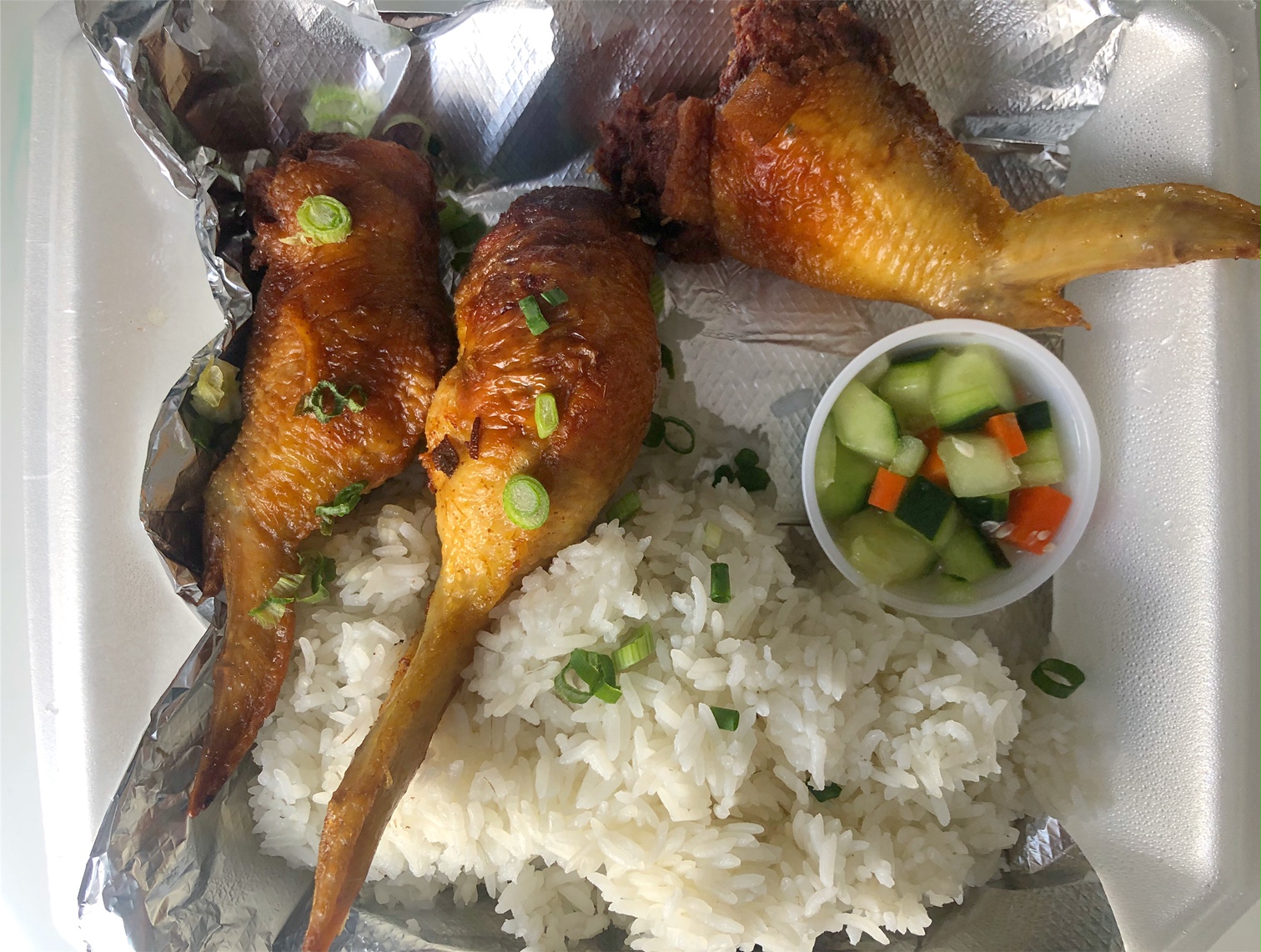 The stuffed wings meal from A Taste of Both Worlds has three wings with steamed rice and a small cup of cucumber salad. Photo by Alyssa Buckley.