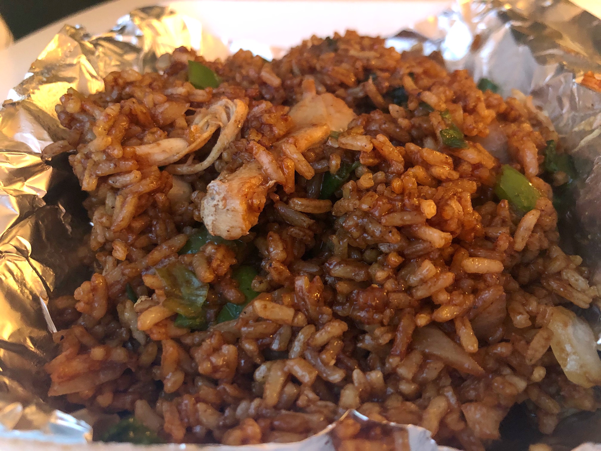 Fried rice from Elnora's Catering & Cafe features dark brown rice with green onion, white onion, green bell pepper, and chicken slices. Photo by Alyssa Buckley.