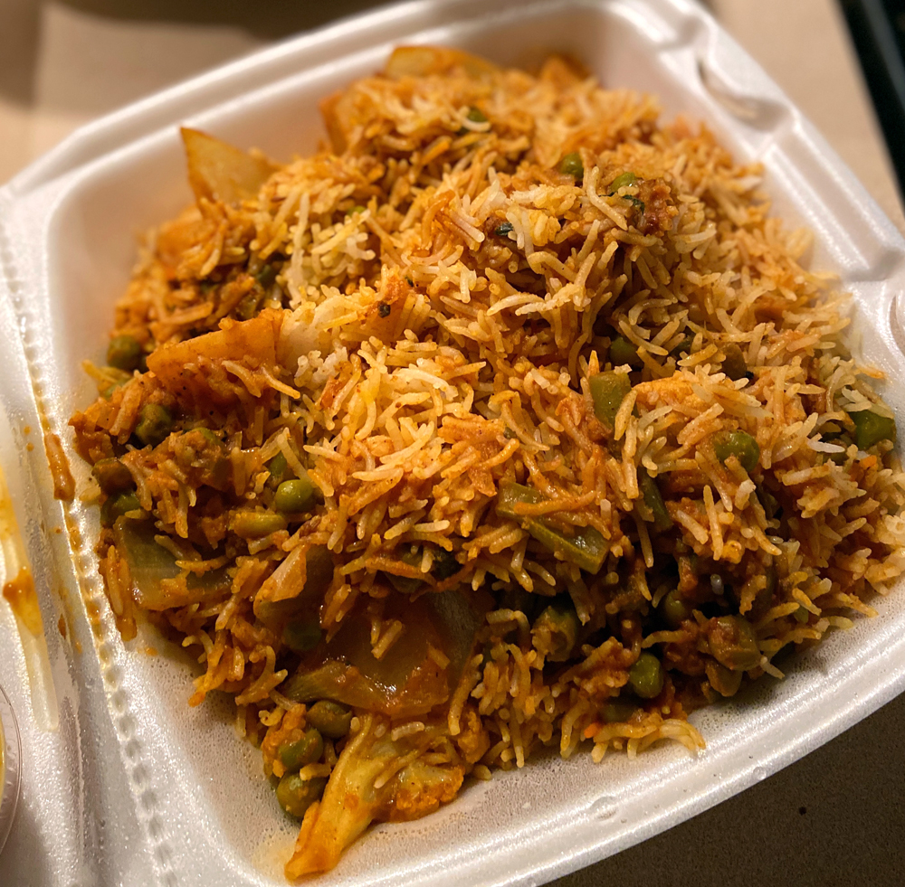 Vegetable biryani from Kohinoor. A rice dish with vegtables in a white styrofoam container. Photo by Jessica Hammie.
