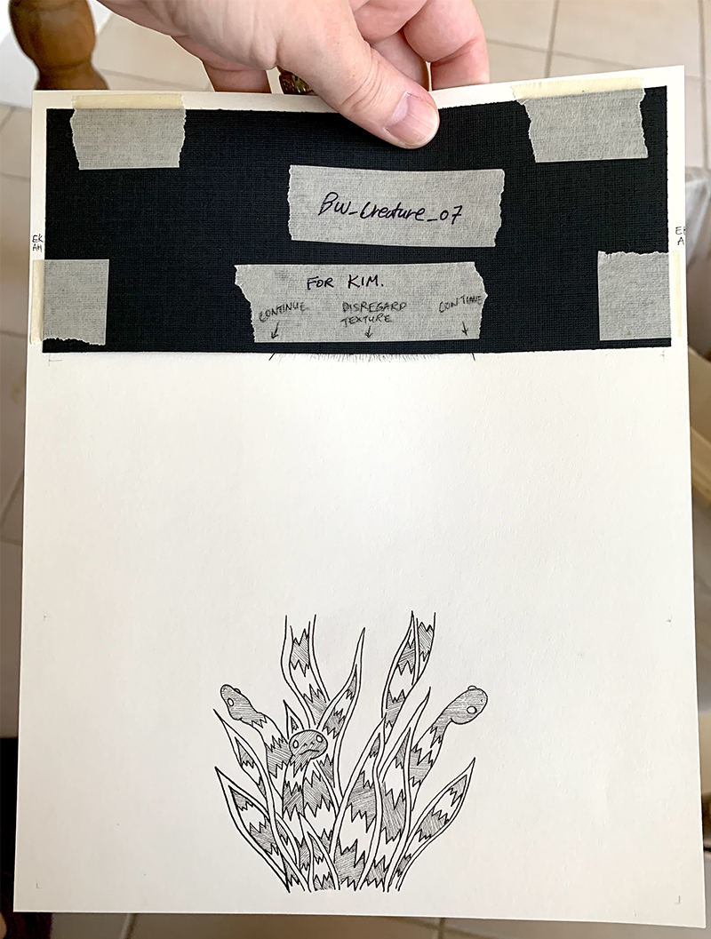 Sample page of Exquisite Trio work in progress with notes in tape over blacked out section on top and b&w drawing of a plant at the bottom . Photo courtesy of Lydia Puddicombe.