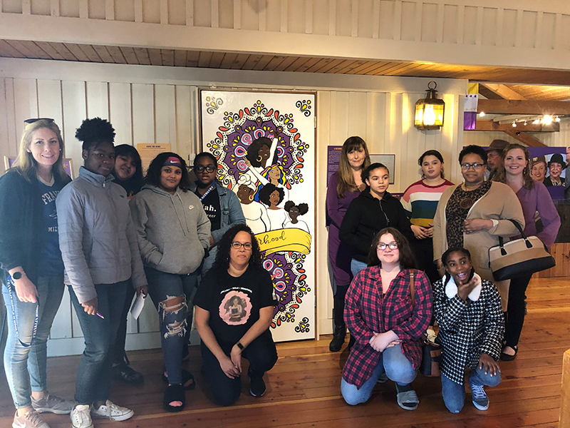 Members of the Sisterhood Academy, along with members of the Museum staff, in front of their completed mural. Photo courtesy of the Museum of the Grand Prairie.