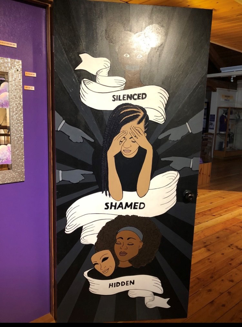 Inner door panel of Sisterhood mural featuring the words 
