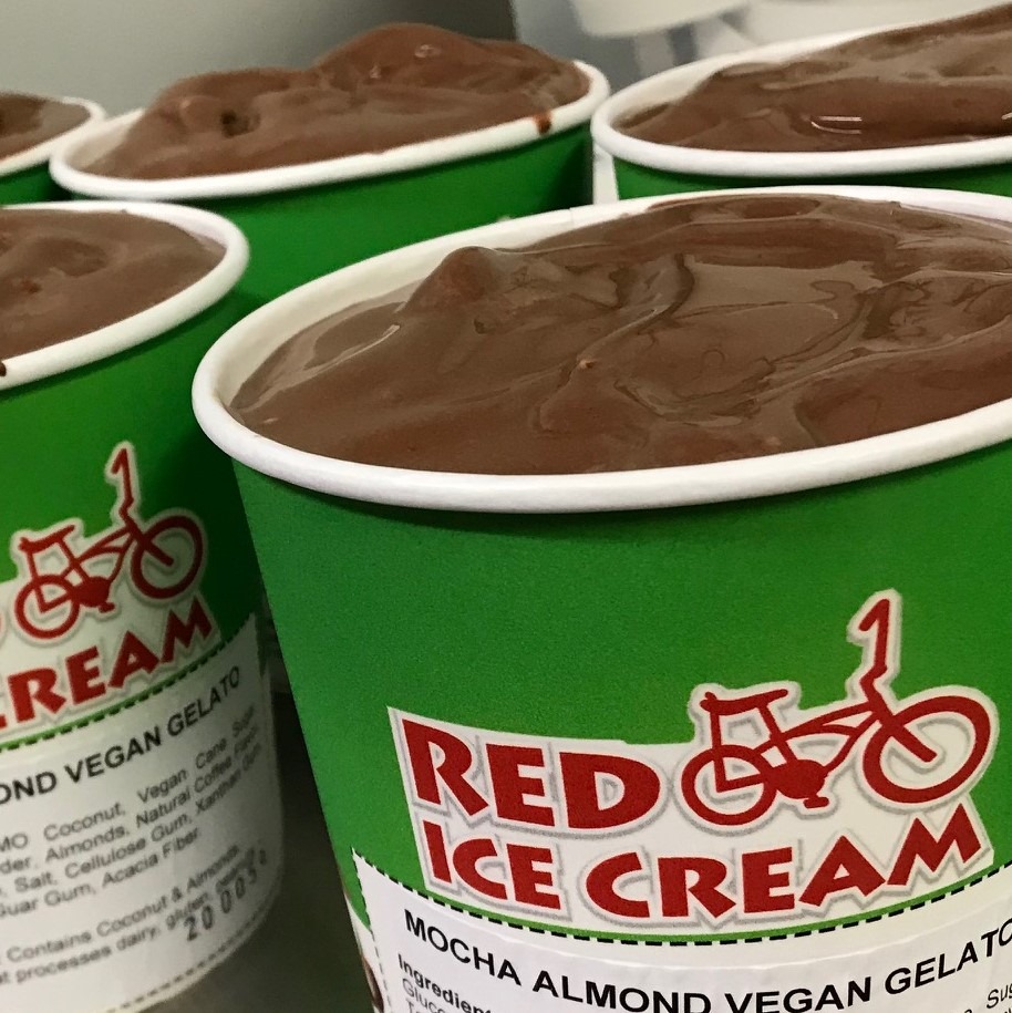 Several pints of chocolate vegan ice cream from Red Bicycle in Urbana are in green paper pint cups, uncovered. Photo from Red Bicycle Ice Cream's Facebook page. 