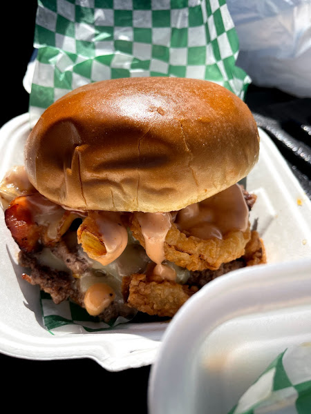 The city slicker burger from Smith Burger Co. has onion rings and a reddish sauce. Photo by Remington Rock.