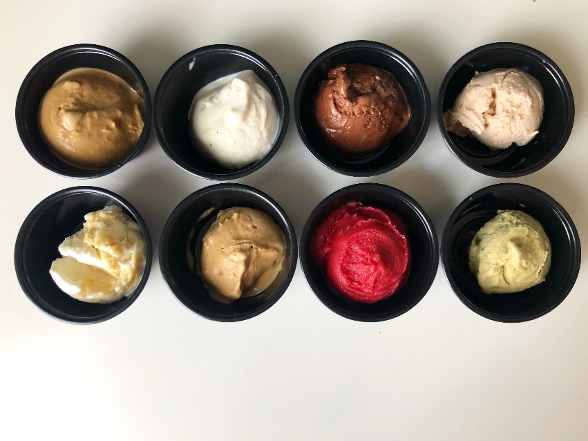 Eight small cups of gelato from Baldarotta's are on a white table. Photo by Alyssa Buckley.