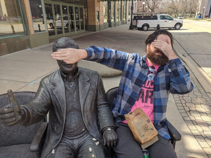 The writer is covering his eyes with one hand, and using his other had to cover the eye of Roger Ebert. Photo by Andrea Black.