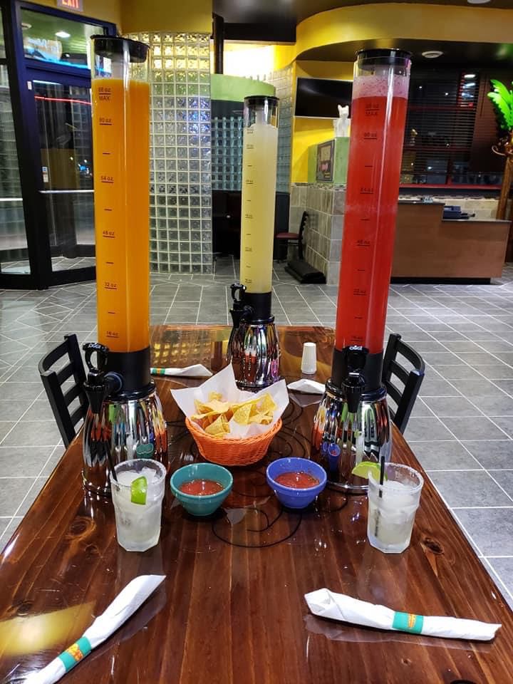 Three towers of margarita (mango, banana, and raspberry) sit on a table at Las Palmas in Champaign with chips and salsa. Photo from Las Palmas Facebook page.