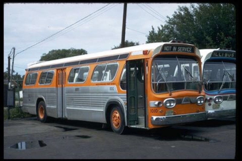 Two vintage silver busses with orange and blue detailing are lined up in a parking lot. One says NOT IN SERVICE and the other says ILLIBUS. BusTalk U.S. Surface Transportation Galleries