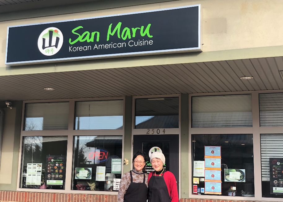 The owners of San Maru stand in the sunny spot in front of their storefront restaurant. Photo by Alyssa Buckley.