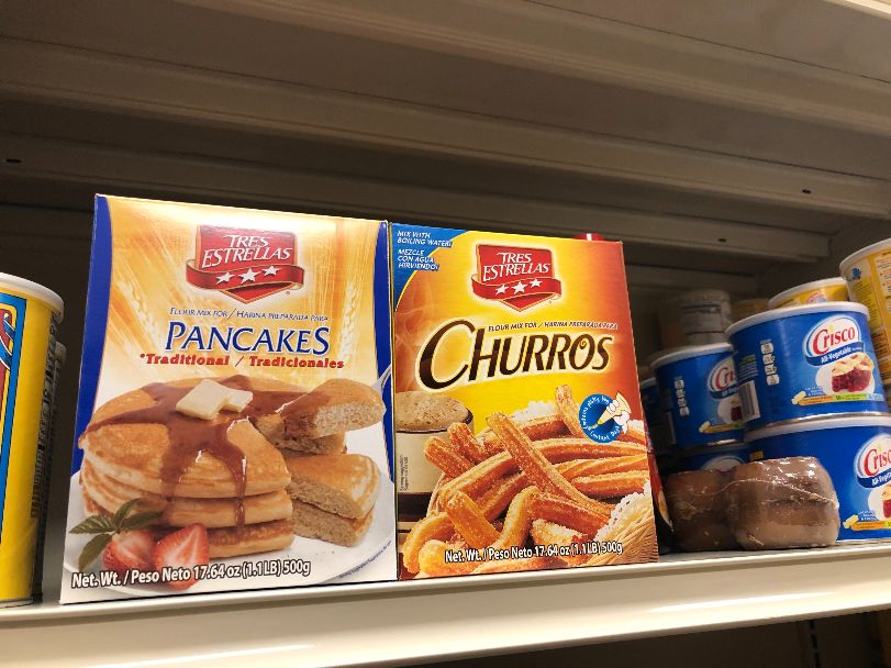 In the baking aisle, boxes of pancake mix and churro sit on a shelf beside Crisco. Photo by Alyssa Buckley.