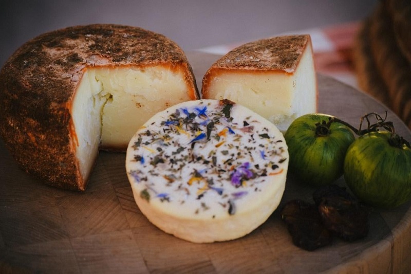 The award winning Fleur de la Prairie and Pelota Roja cheeses covered in a spicy rind and herbs/flowers, respectively. Photo courtesy of Prairie Fruit Farms and Creamery.