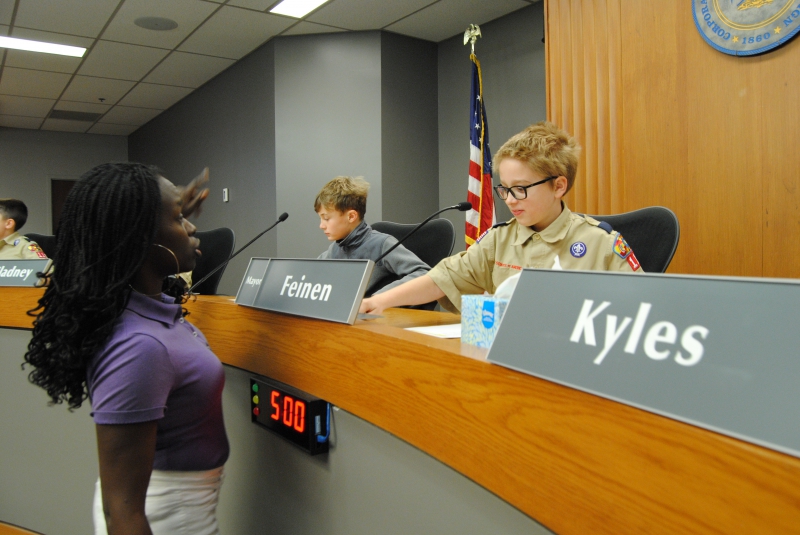 Council member Clarissa Fourman interacts with a boy scout at council chambers in Champaign 