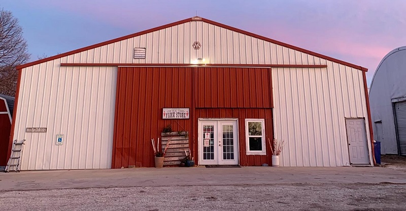 The large shed exterior of Prairie Fruit Farms and Creamery retail front with a set of double doors slightly offset from the center. Photo courtesy of Prairie Fruit Farms and Creamery.