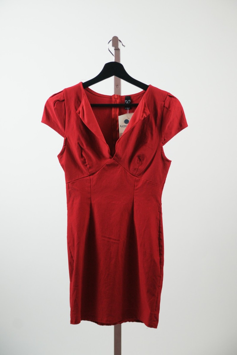 A red dress on a black hanger hangs on a pole. Photo provided by Karma Trade.