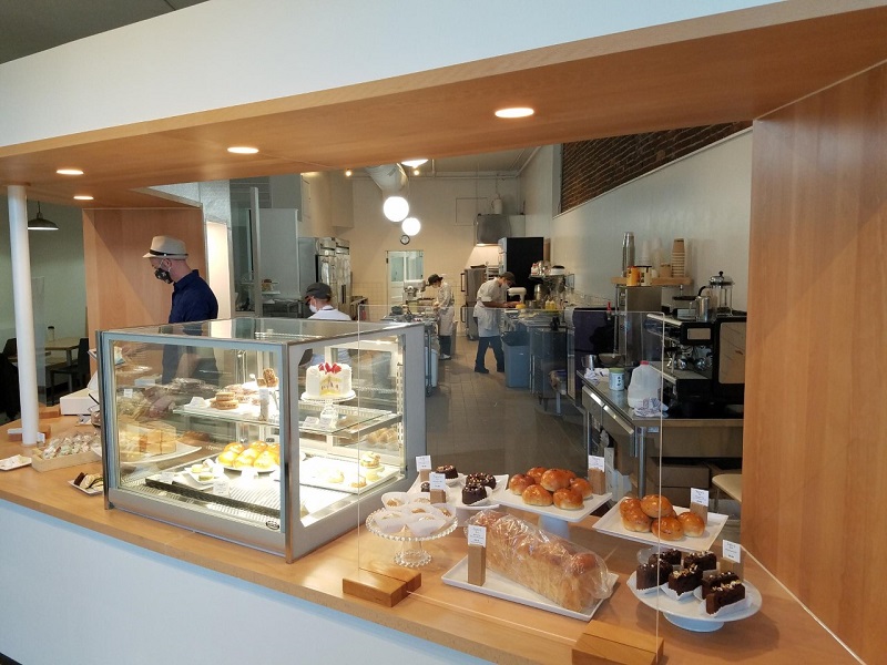 Interior of Suzuâ€™s where baked goods are on display and Suzuâ€™s staff are seen working behind the counter ringing-up orders and preparing more baked goods. Photo by Matthew Macomber.