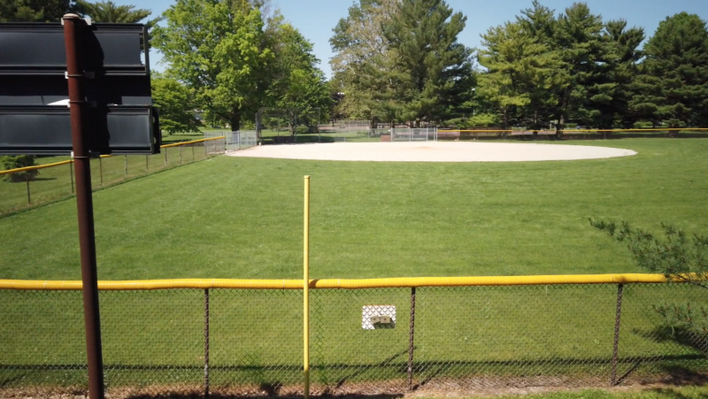 a view of right field of a baseball diamond from behind the outfield fence 
