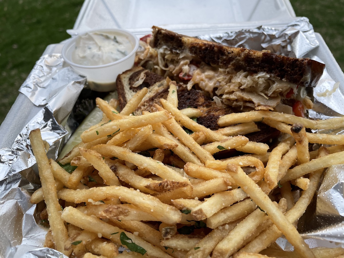 A photo of the vegetarian reuben from Sunsinger in a white styrofoam container. Photo by Anthony Erlinger.