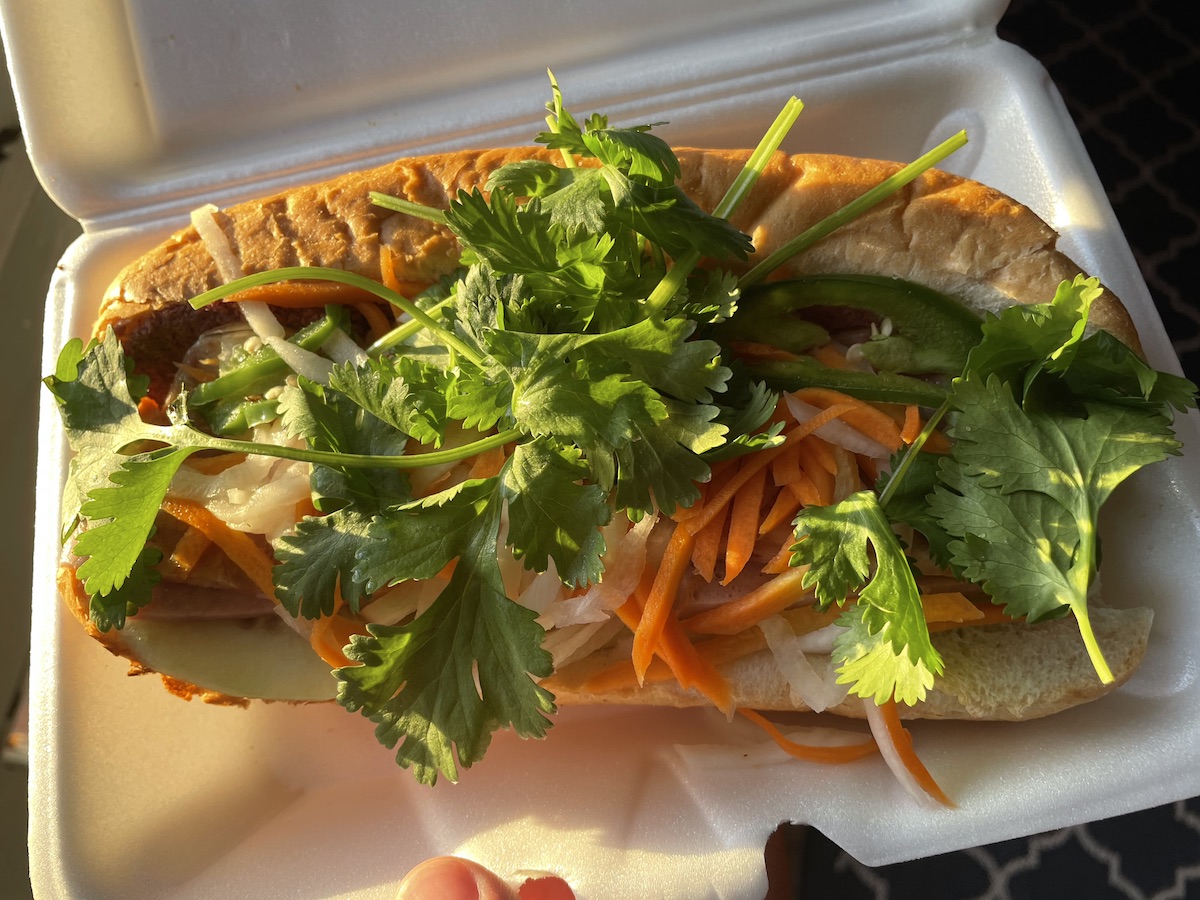 A photo of the Bahn Mi from Xinh Xinh Cafe sits in a white styrofoam container.  Photo by Anthony Erlinger.