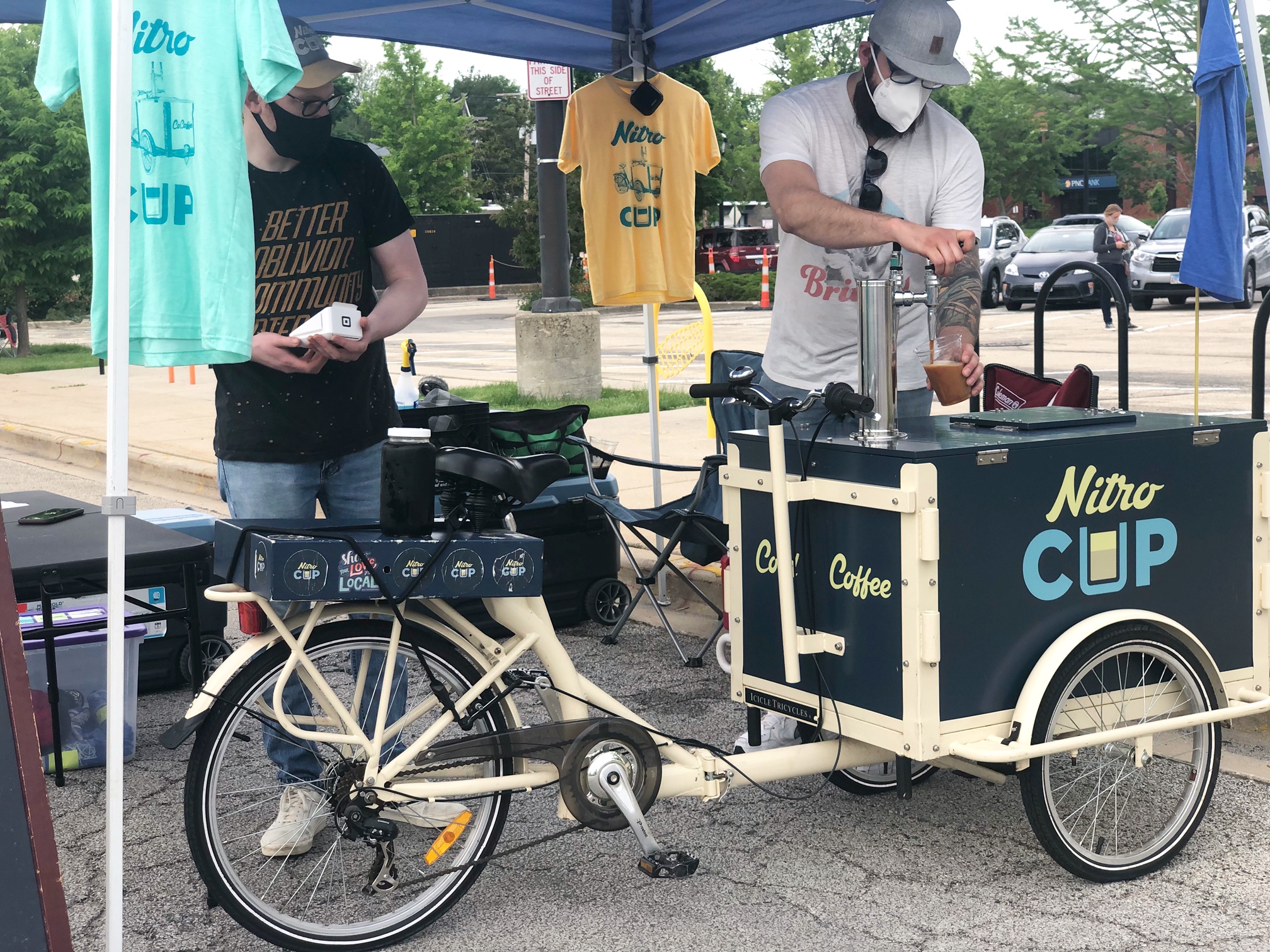 On a bicycle, there is a rectangular cooler for cold brew by Nitro Cup. Photo by Alyssa Buckley.