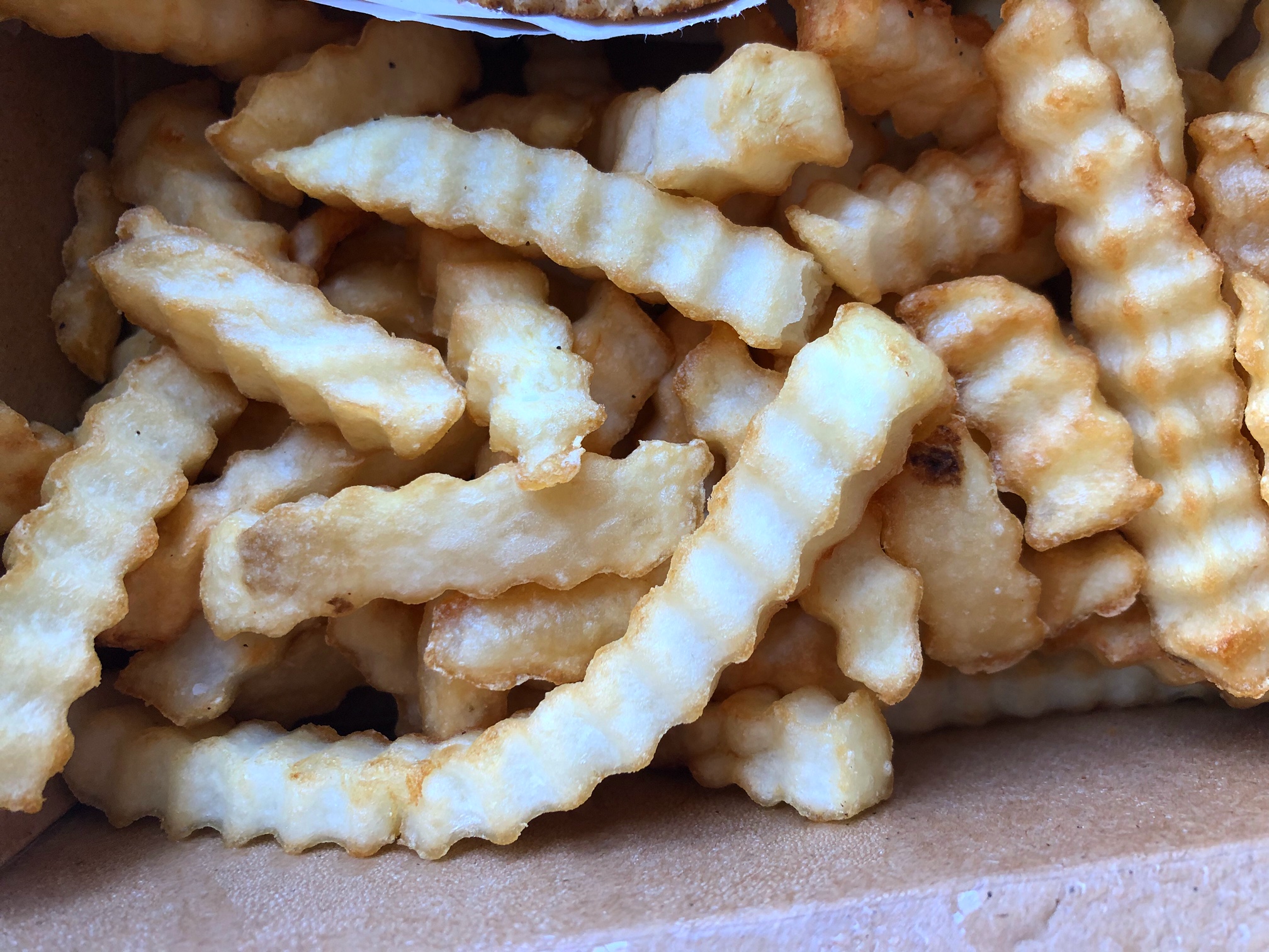 A close up photo of crinkle cut fries from La Royale in Urbana, Illinois. Photo by Alyssa Buckley.