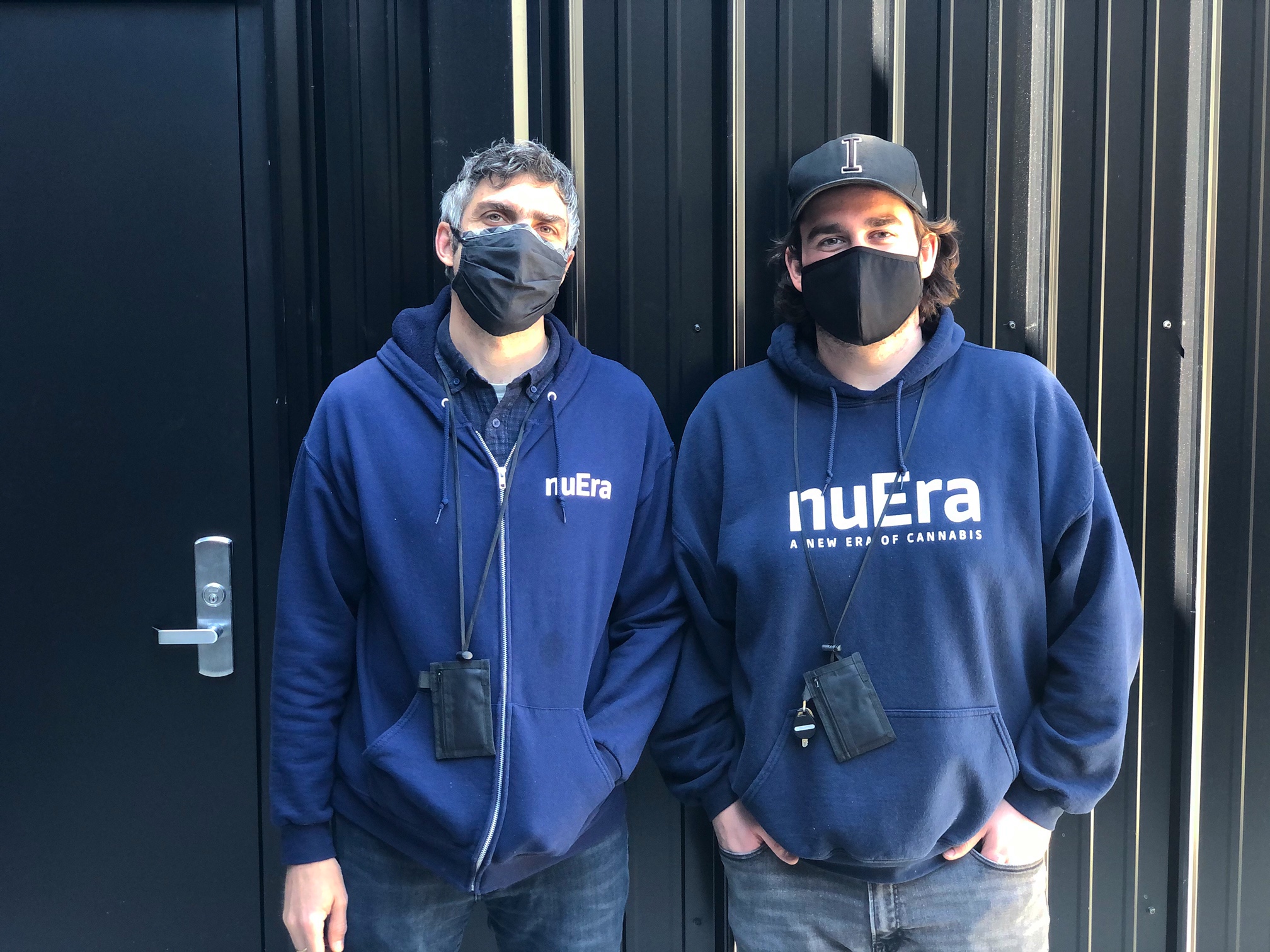 Rapino and Carretto of NuEra stand in front of a black metal building. Photo by Alyssa Buckley.