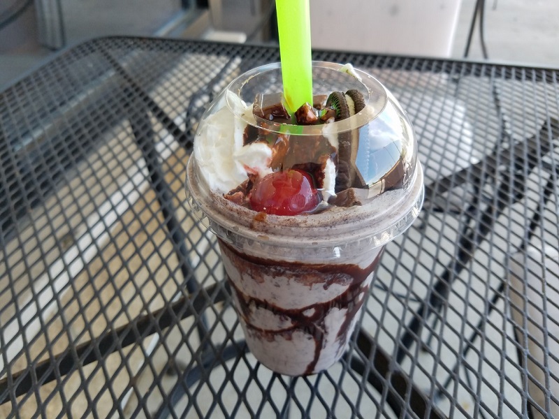 An El Oasis Oreo milkshake in a tall cup with an Oreo, Kit-Kat piece, and cherry seen on top. Photo by by Matthew Macomber.