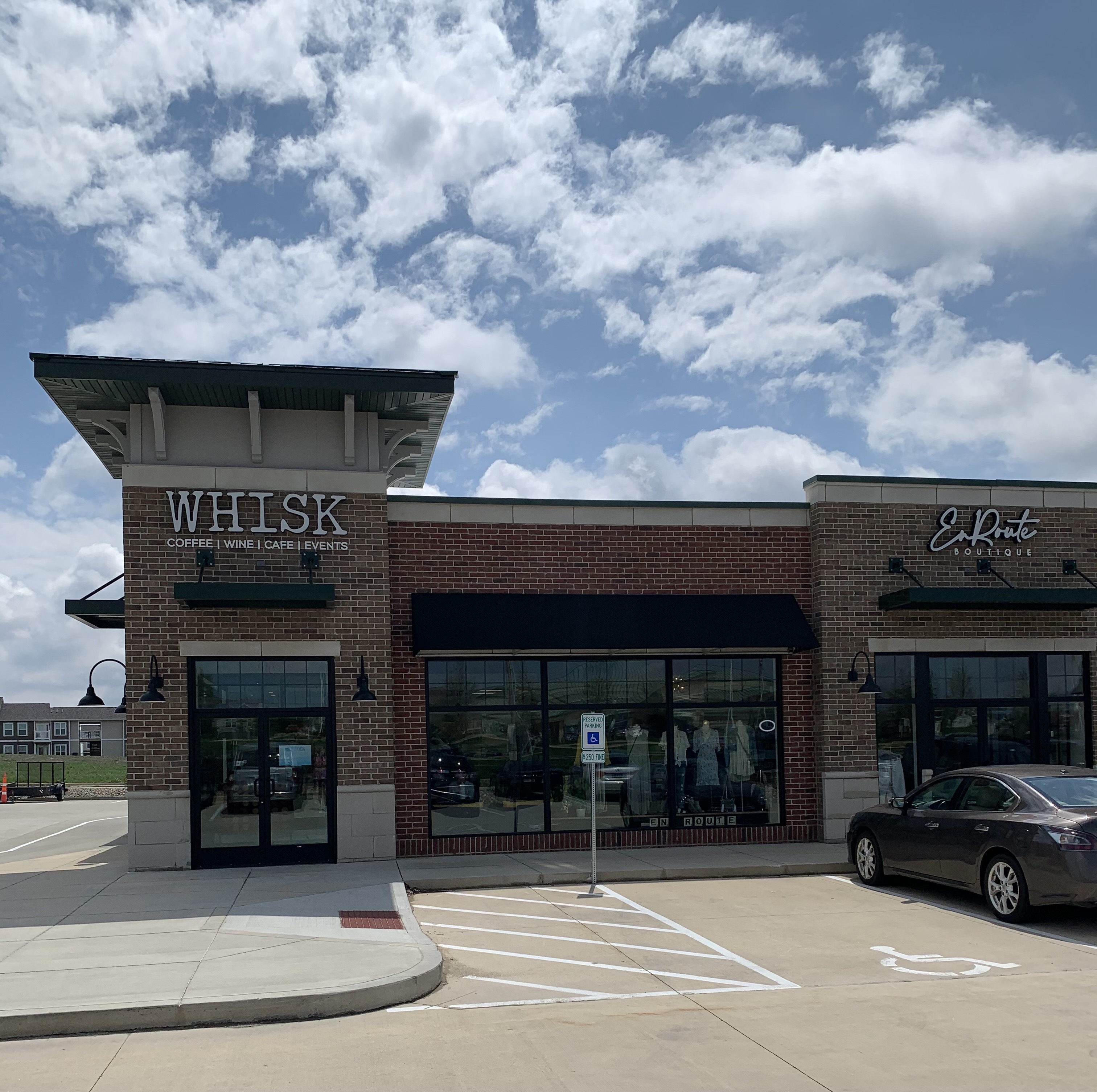 The exterior of Whisk is a brick building beside a boutique in Mahomet. Photo by Stephanie Wheatley.