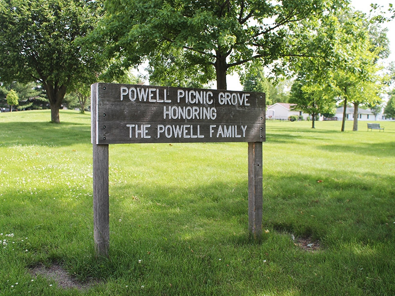 a wooden sign honoring the Powell family 