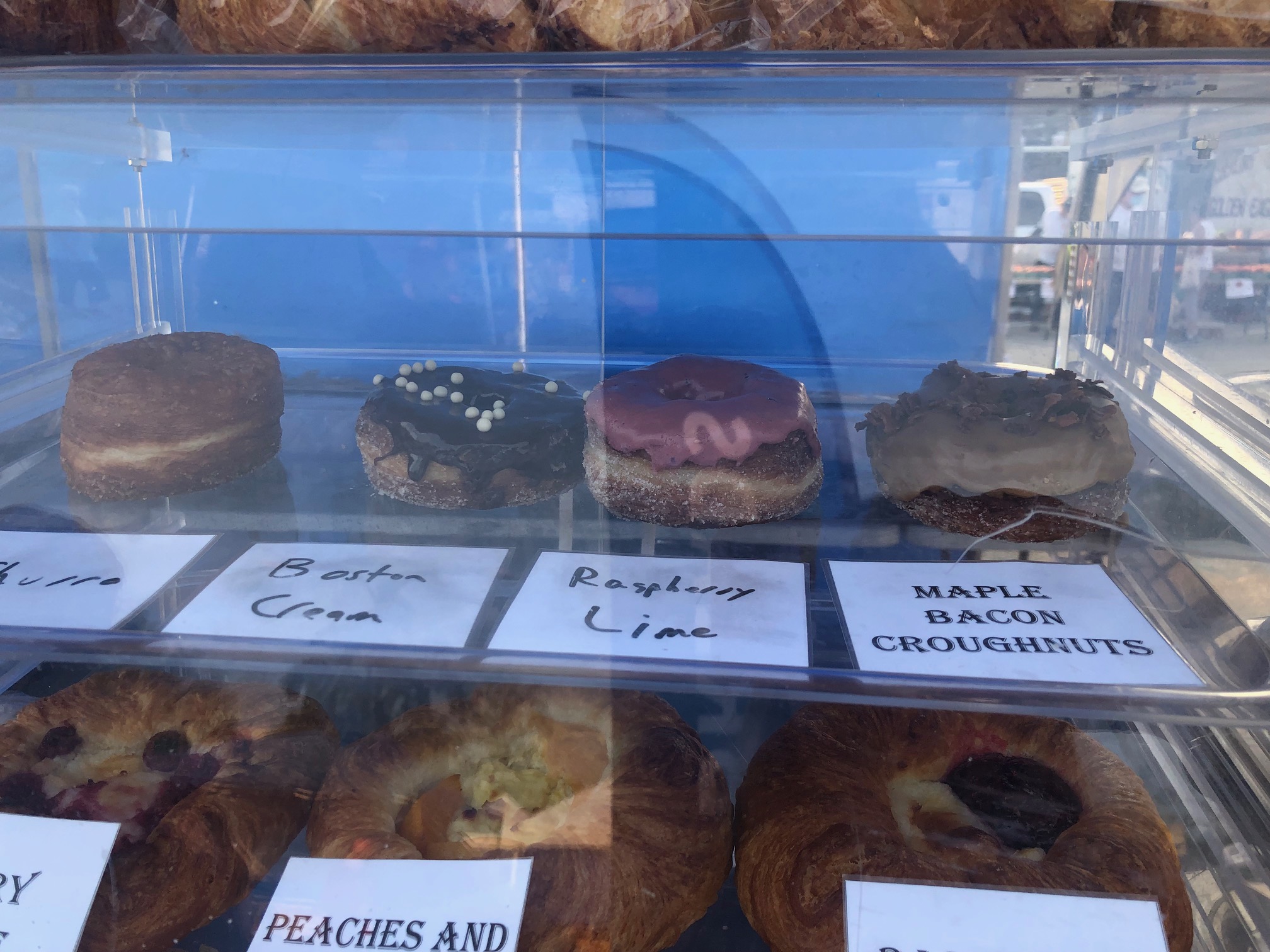 A photo of the case of cronuts sold by Central Illinois Bakehouse featuring the four flavors of cronut for sale that day. Photo by Alyssa Buckley.