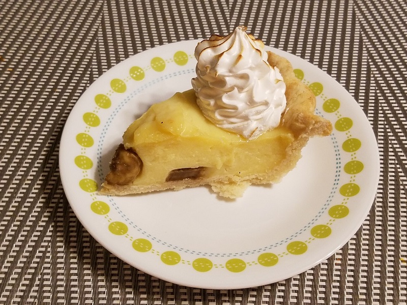 A slice of banana cream pie on a small plate with the banana slightly darked because it was left in the fridge overnight. Photo by Matthew Macomber.