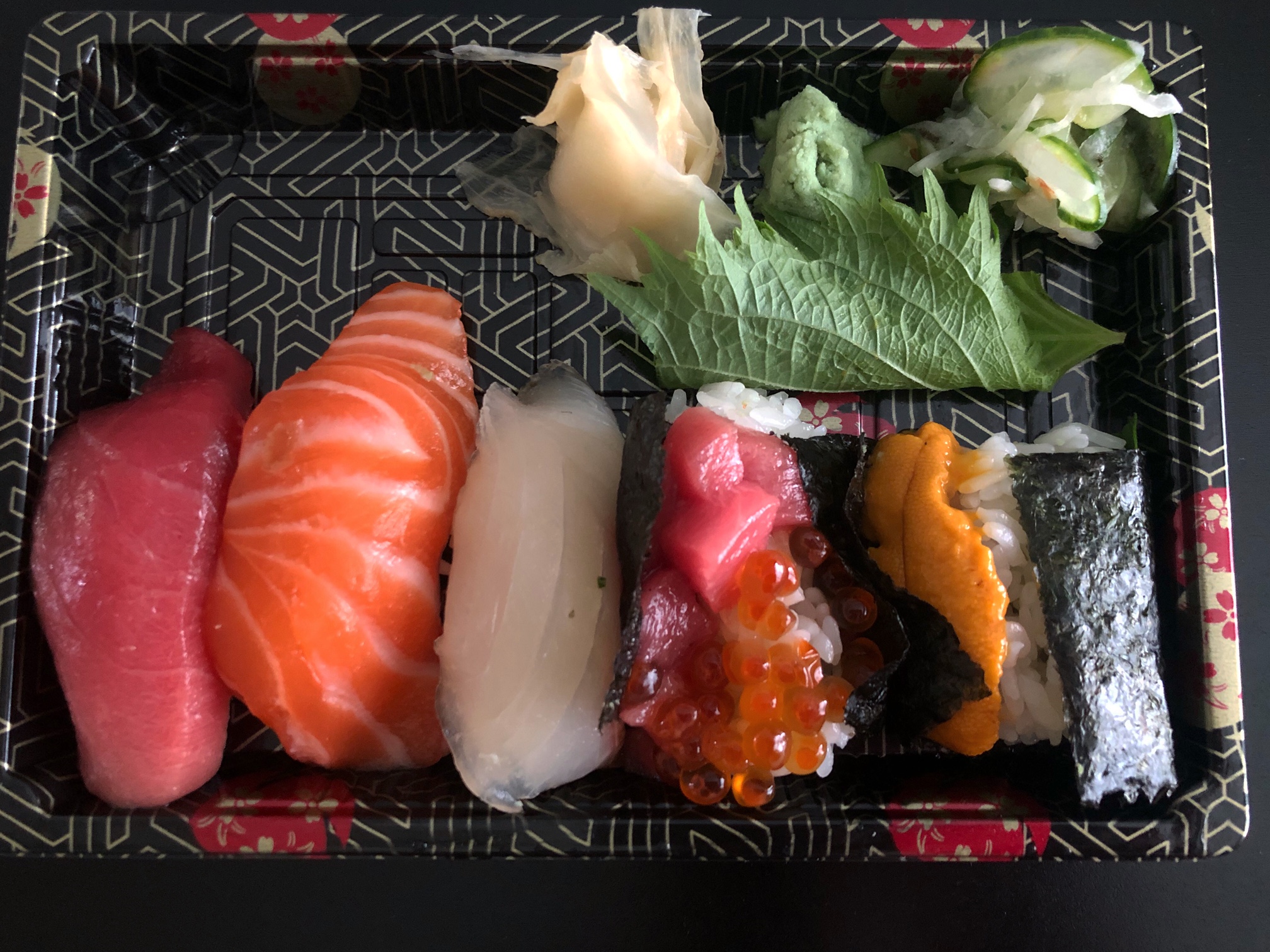 From above, there is a rectangular container with five pieces of nigiri. Photo by Alyssa Buckley.