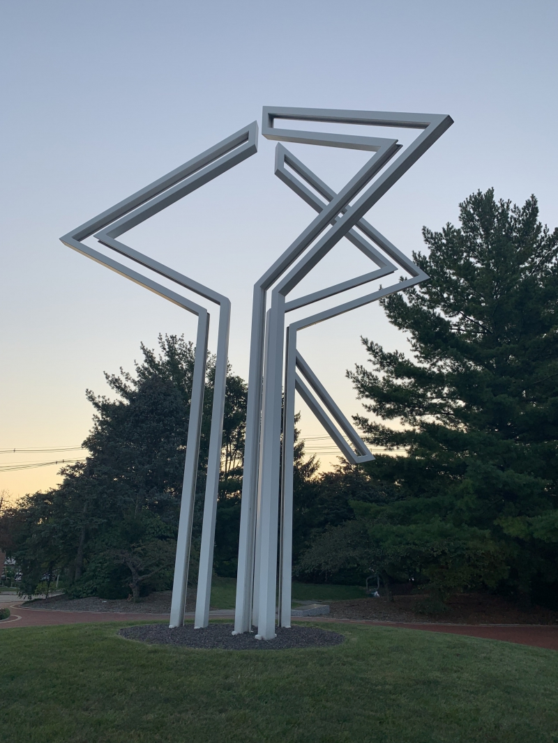 a tall white modern art sculture 