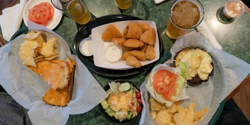 An overhead photo shows the author's bar food at Bunny's and two half drank beers. Photo by Jordan Goebig.