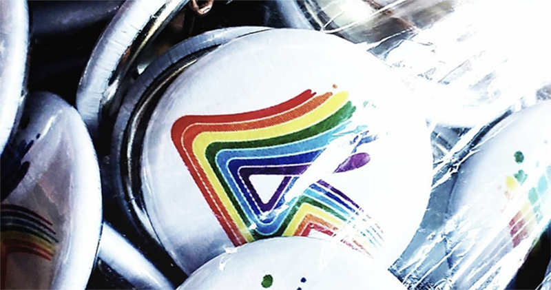 Photo of Pride buttons with Prism Studios rainbow logo. Photo from Prism Studios Instagram.