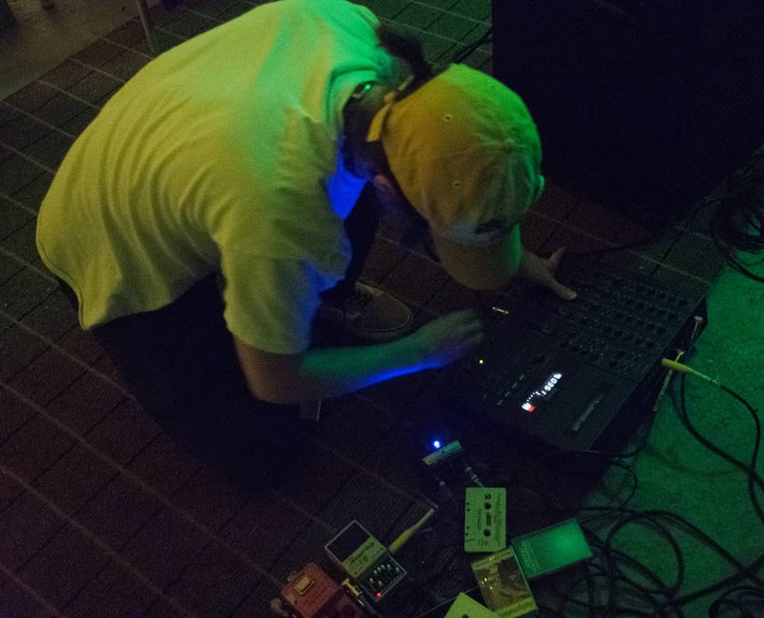 Image of Vor Pilatus tinkering with effects pedals. 