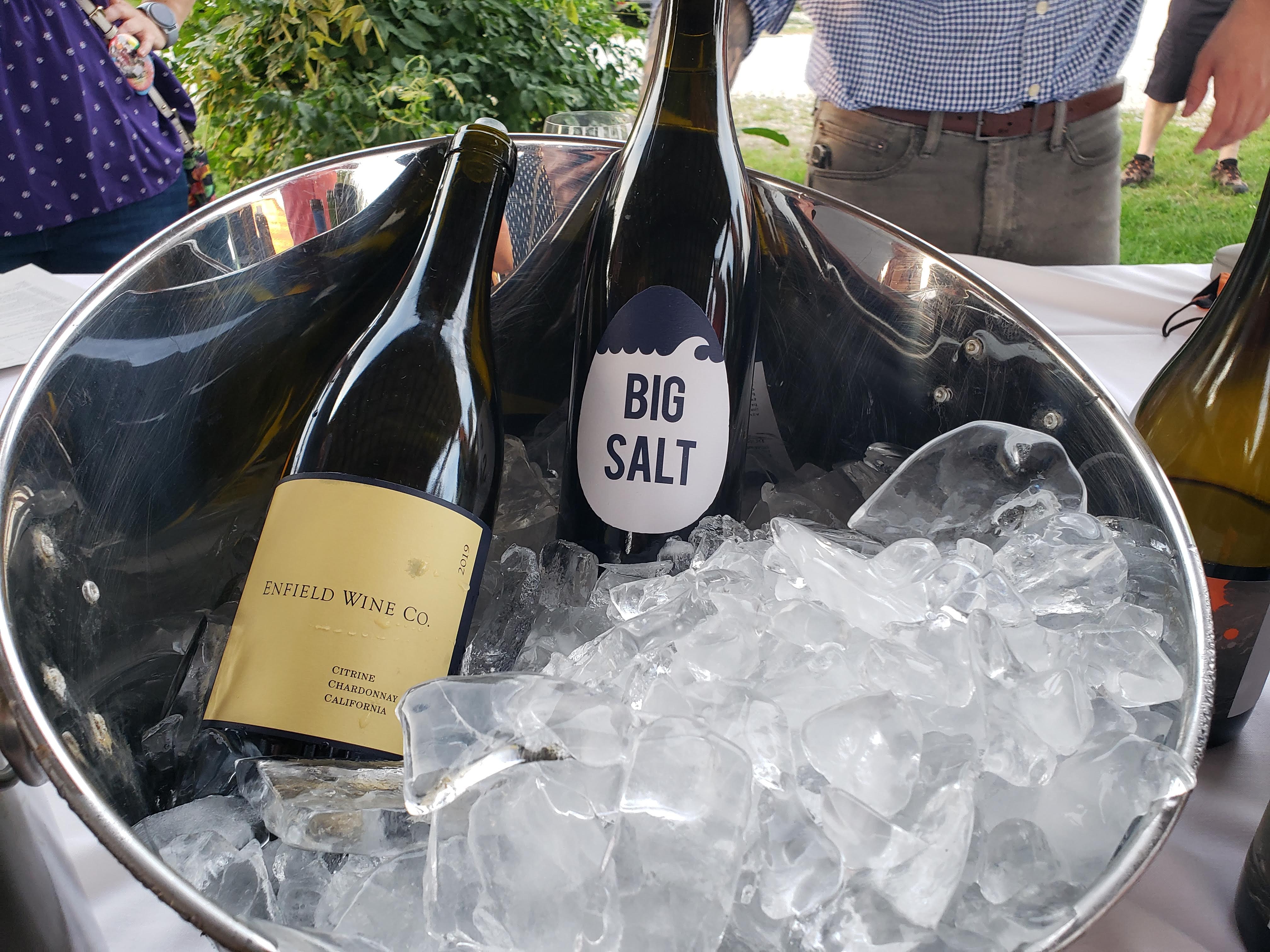 In a bucket of ice, there are two open wine bottles at an Art Mart + PFF tasting event. Photo by Sara Ressing.