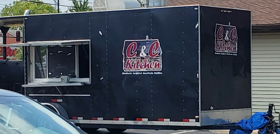 A black food truck with the words 