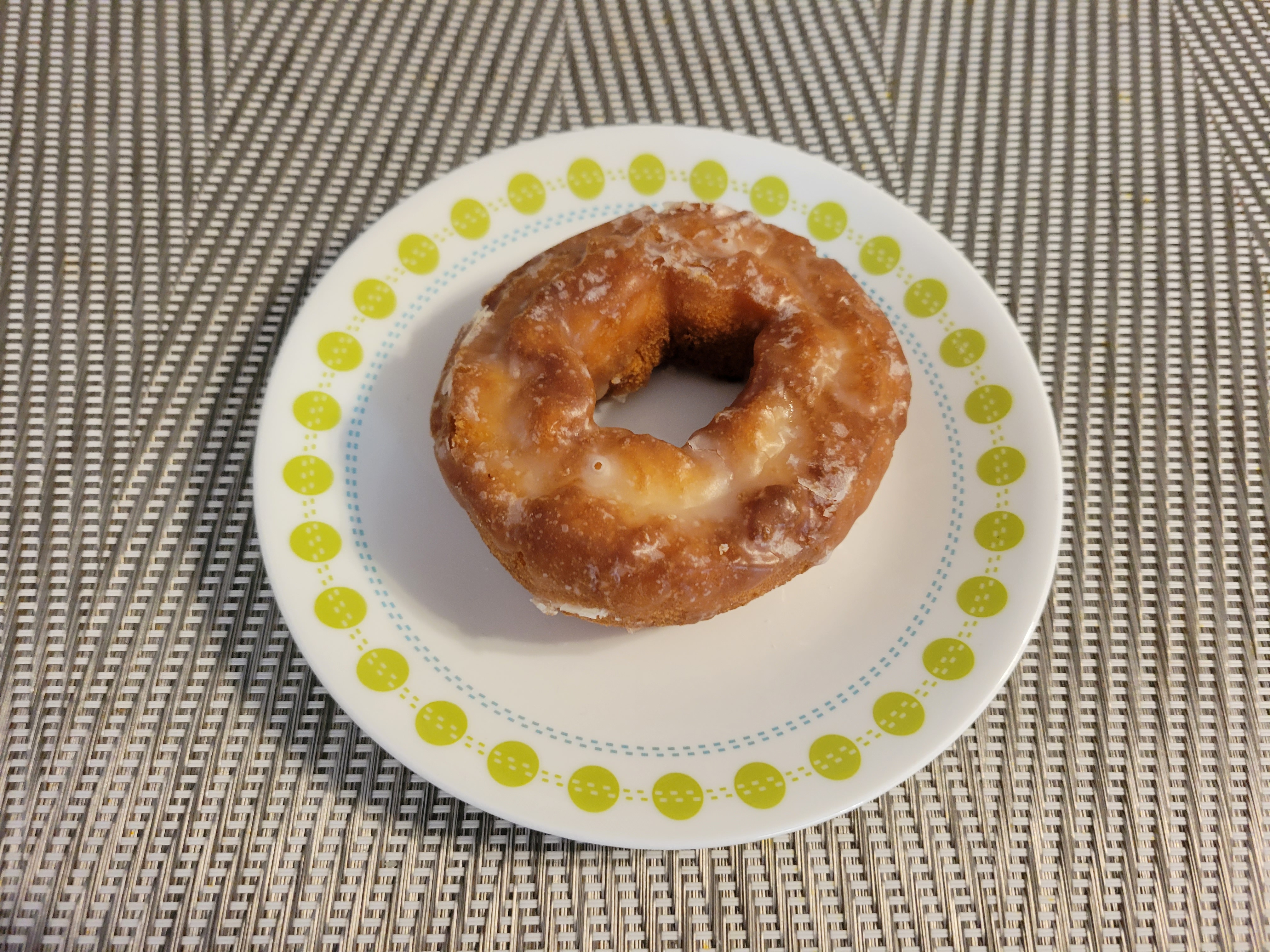 A glazed cake donut on a small plate. Photo by Matthew Macomber.