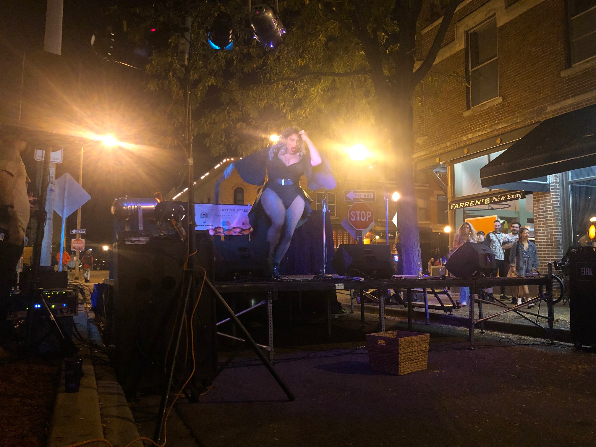 A pantsless drag performer in a beautiful black leotard with a cape performs at Toast to Taylor Street in Champaign. Photo by Alyssa Buckley.