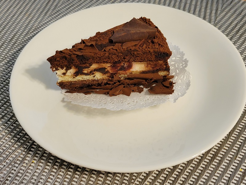 Selva Nera Cake sitting on a paper lace display on a small plate. Photo by Matthew Macomber.