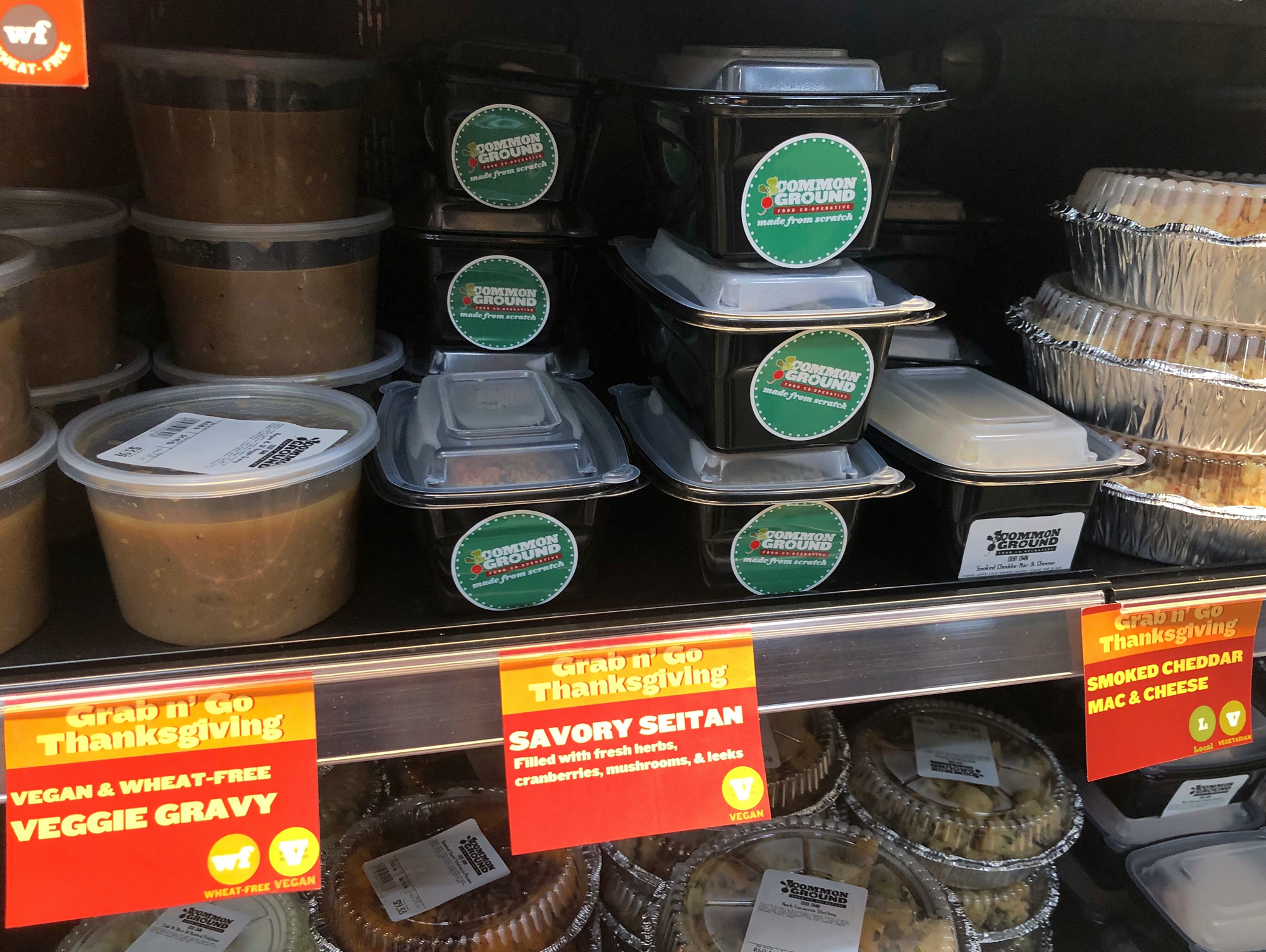 Vegan and wheatfree options are available in the grab-and-go section at Common Ground. There are little orange signs with the names of the dishes. Photo by Alyssa Buckley.