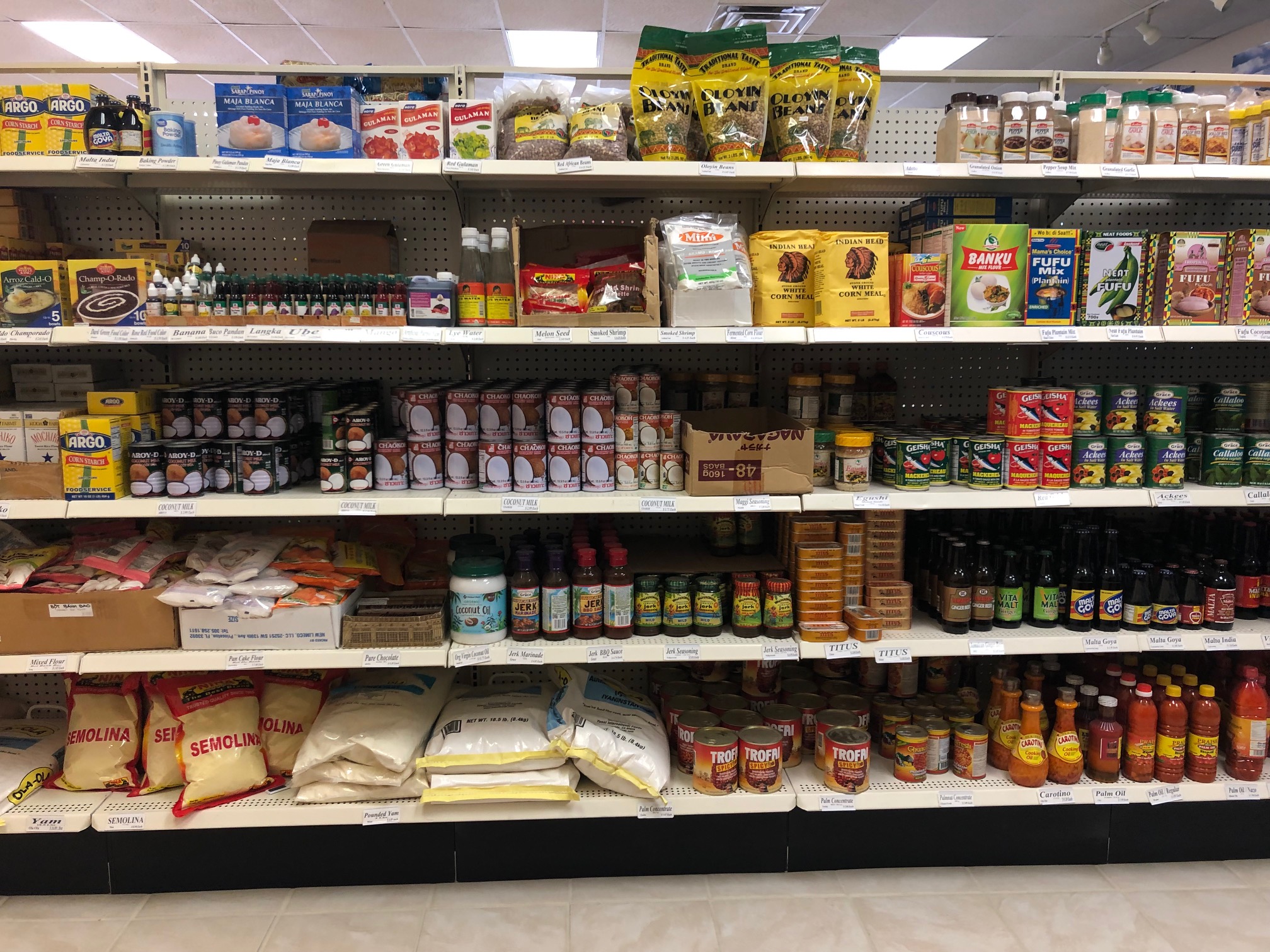 A wide shot shows the entire aisle at the back of the store which has jars, cans, and bags of Filipino foods. Photo by Alyssa Buckley.