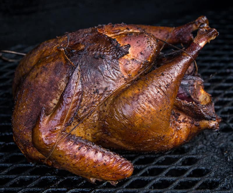 On a black grill, there is a crispy, dark colored full turkey smoked at Project 47 Steakhouse Pub & Patio. Photo from Project 47 Steakhouse Pub & Patio's Facebook page.