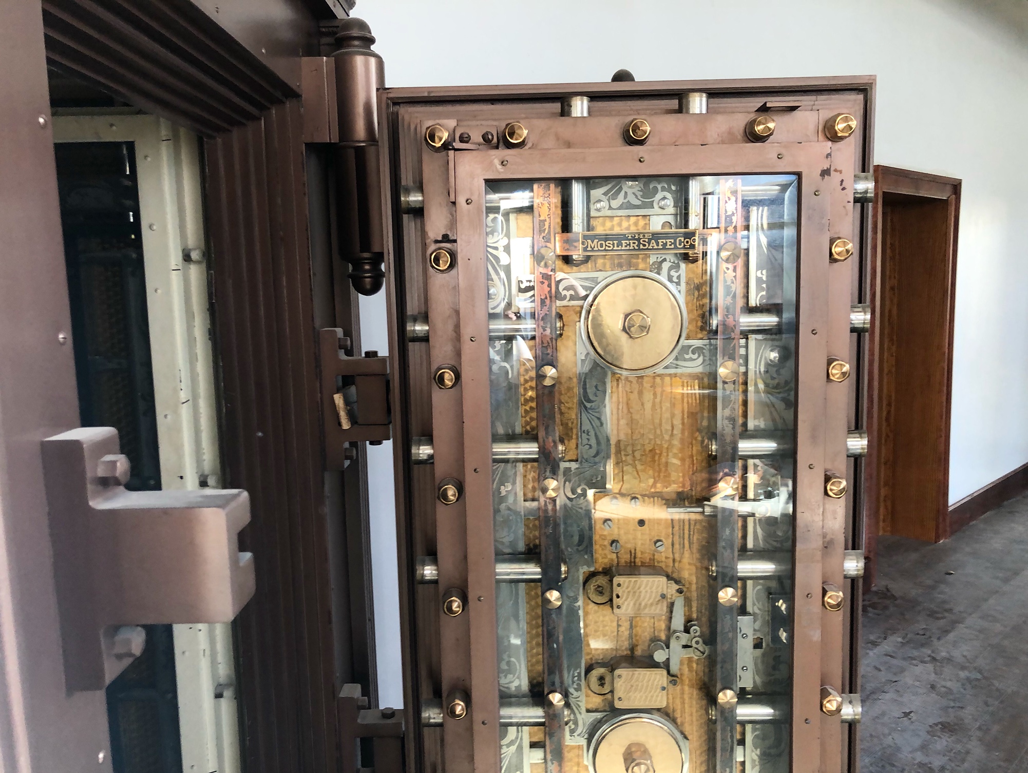 Inside a Downtown Urbana building, there is an open vault with an intricate locking set up on the metal vault door. Photo by Alyssa Buckley.