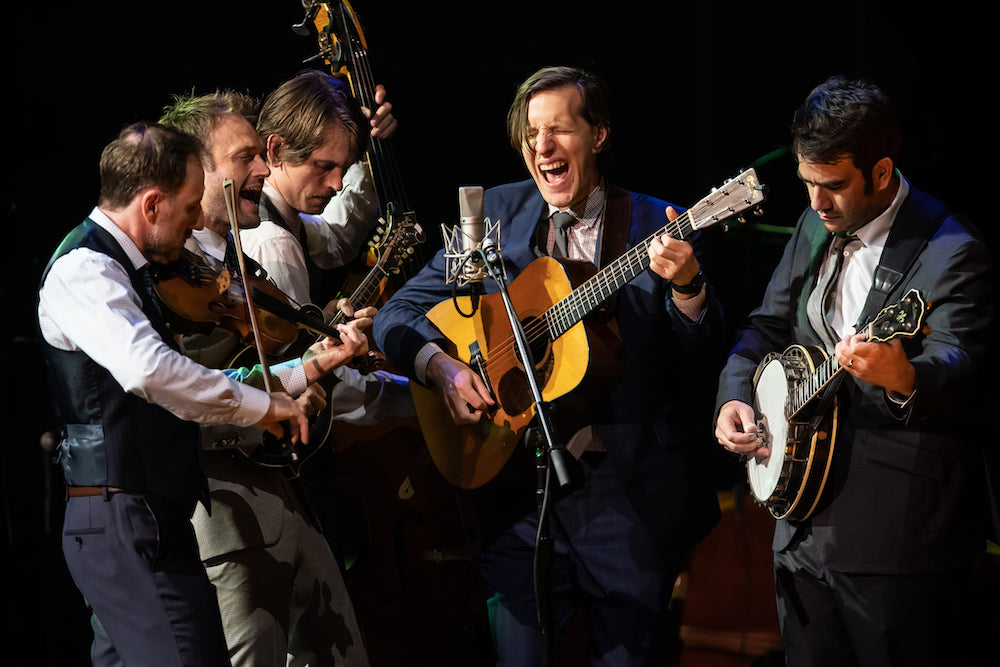 Action shot of the Punch Brothers performing on stage. 